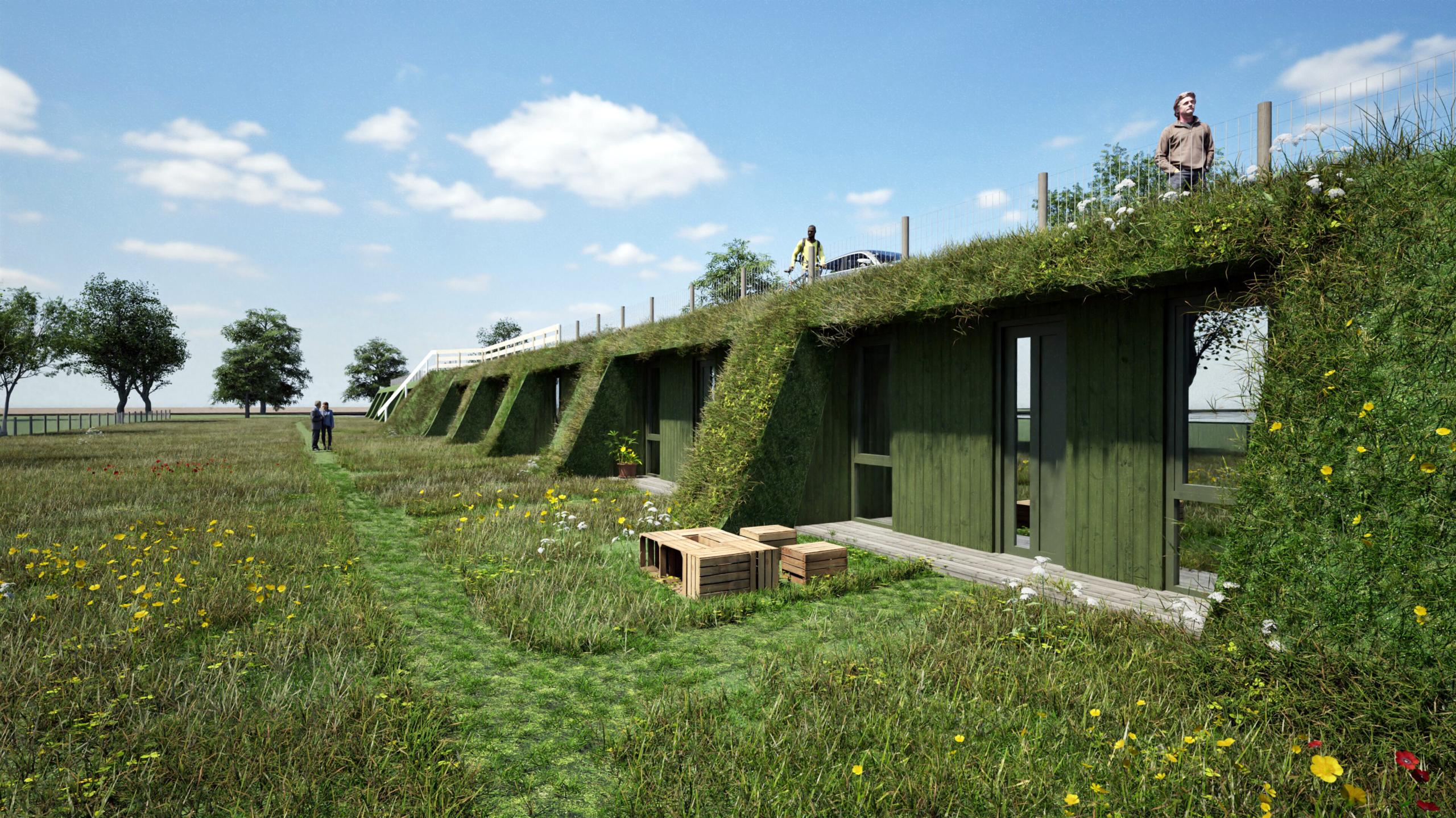 Groen gebladerte huis met grasdak, omgeven door bloemen en gras, enkele personen op het dak en wandelpad op grasveld.