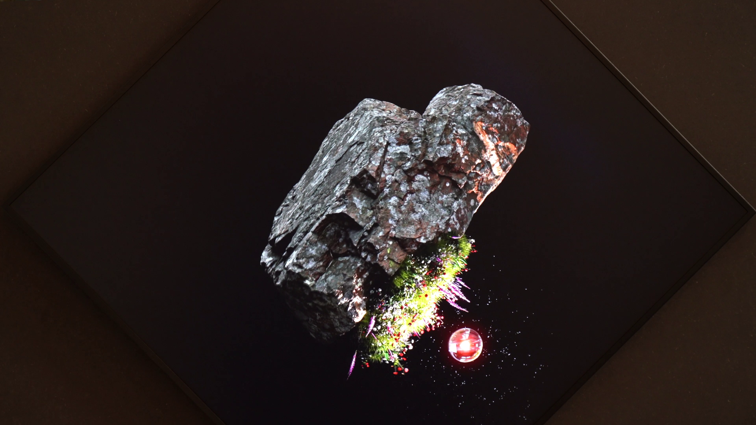 Zwevend stuk rots met planten en een rode bol op een zwart scherm.